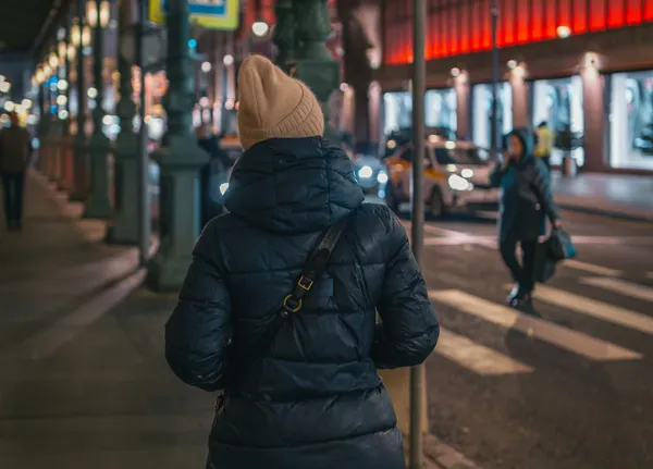 Woman walking the streets by night